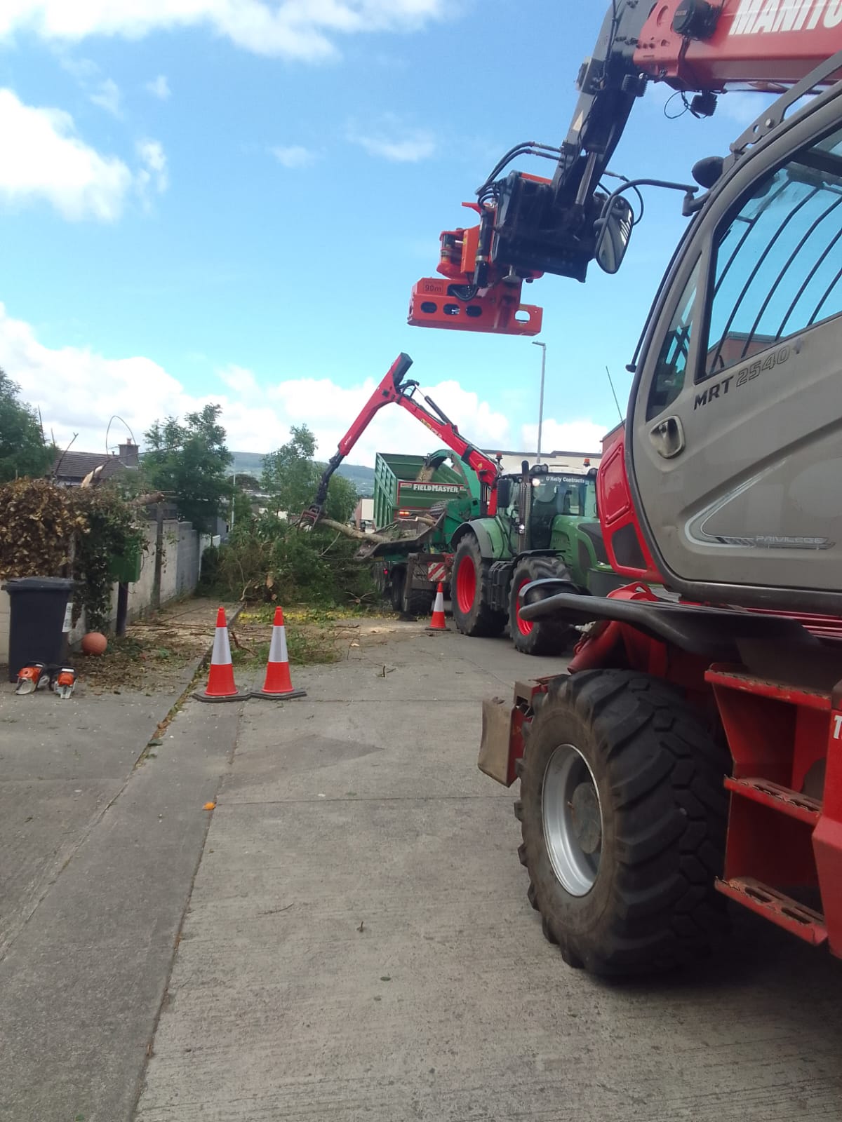 Urban site clearance with Manitou and tractor loading felled timber