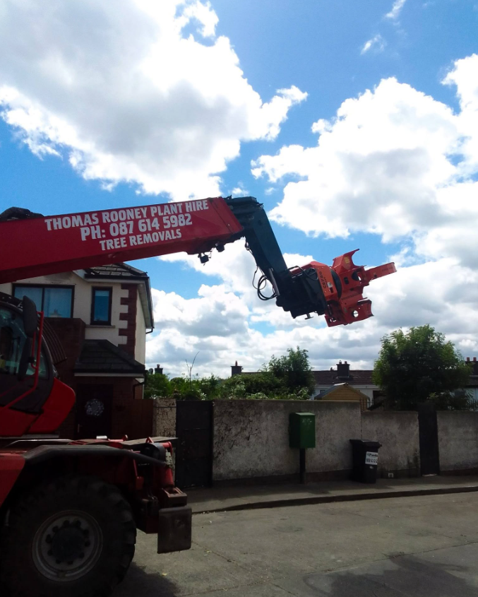 Machinery arm and attachment over residential area