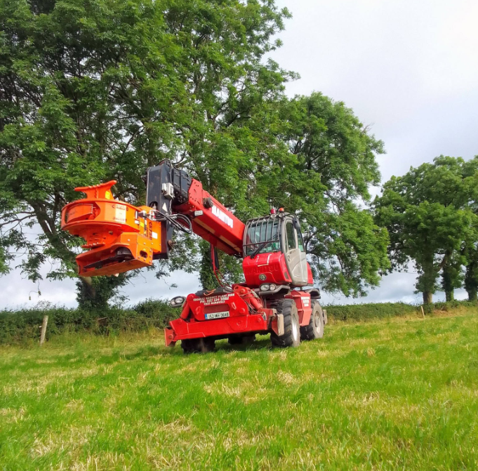 Machine set up in a field for land management works